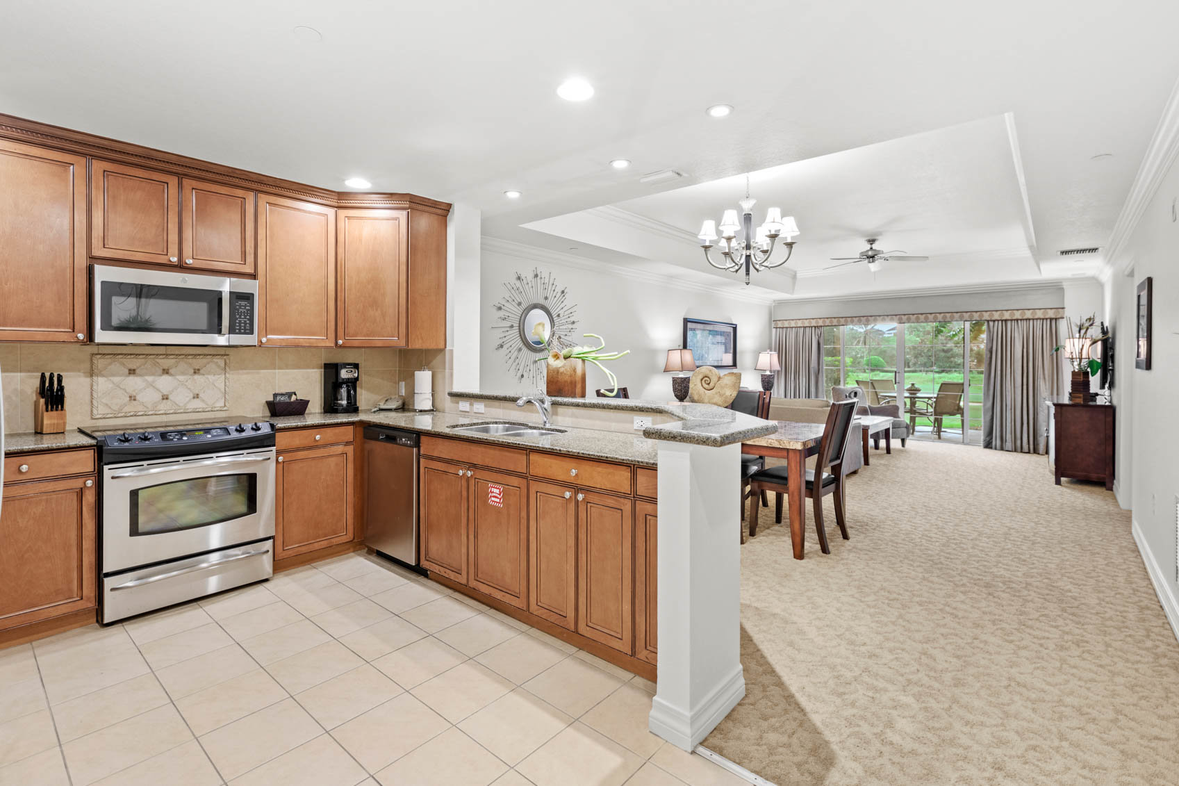 kitchen and living room in a condo with wooden furniture